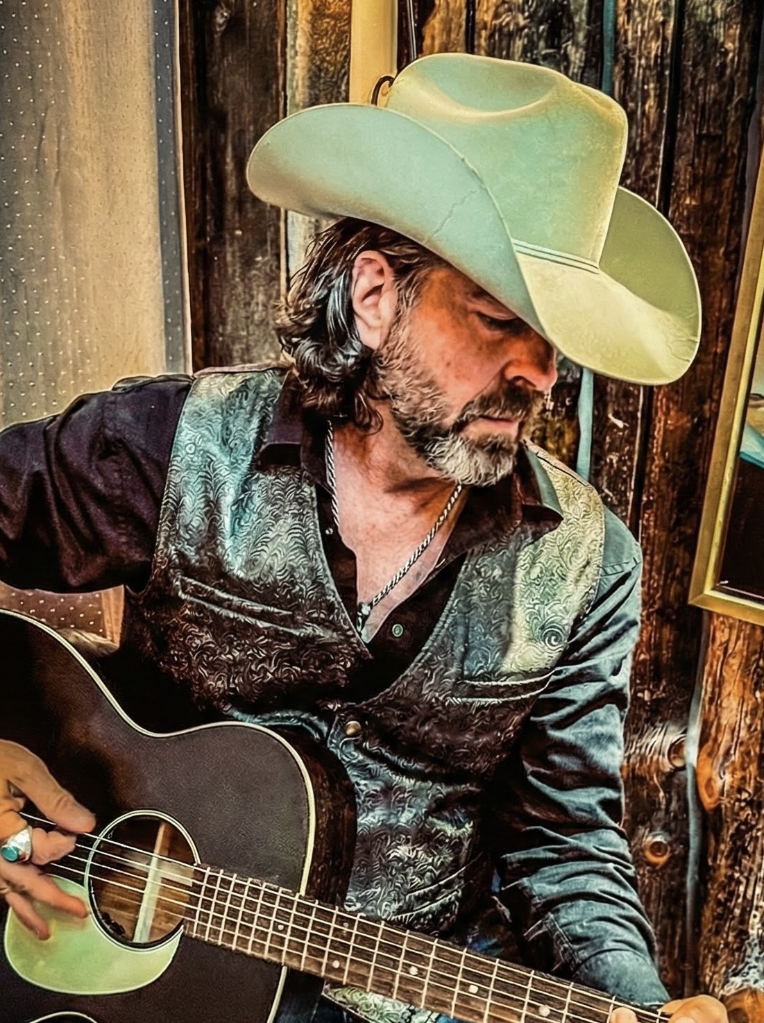 Scott Gray playing acoustic guitar